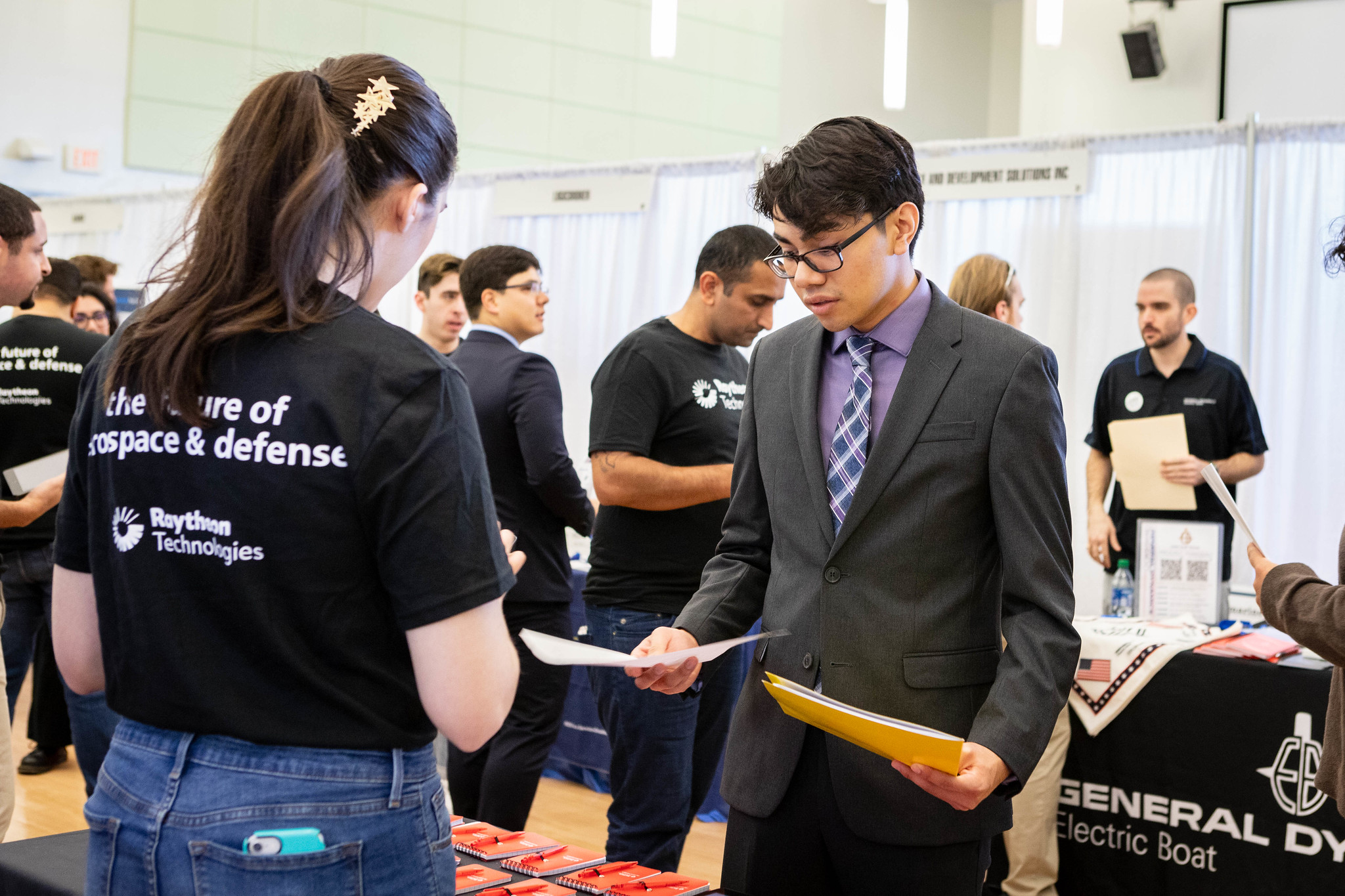 A student talks to an employer at a career fair.