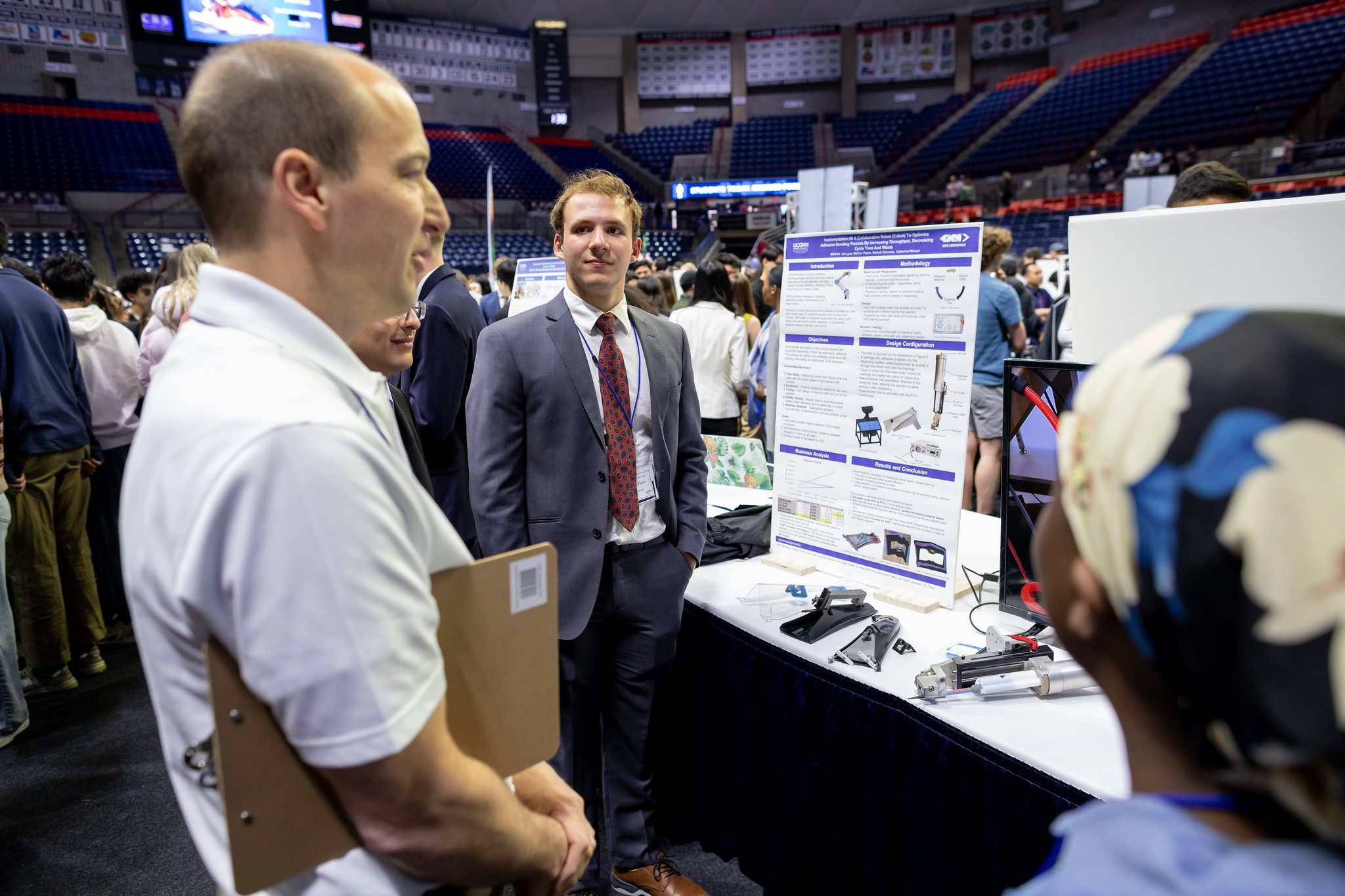 Students present their project to a judge in Gampel Pavilion.